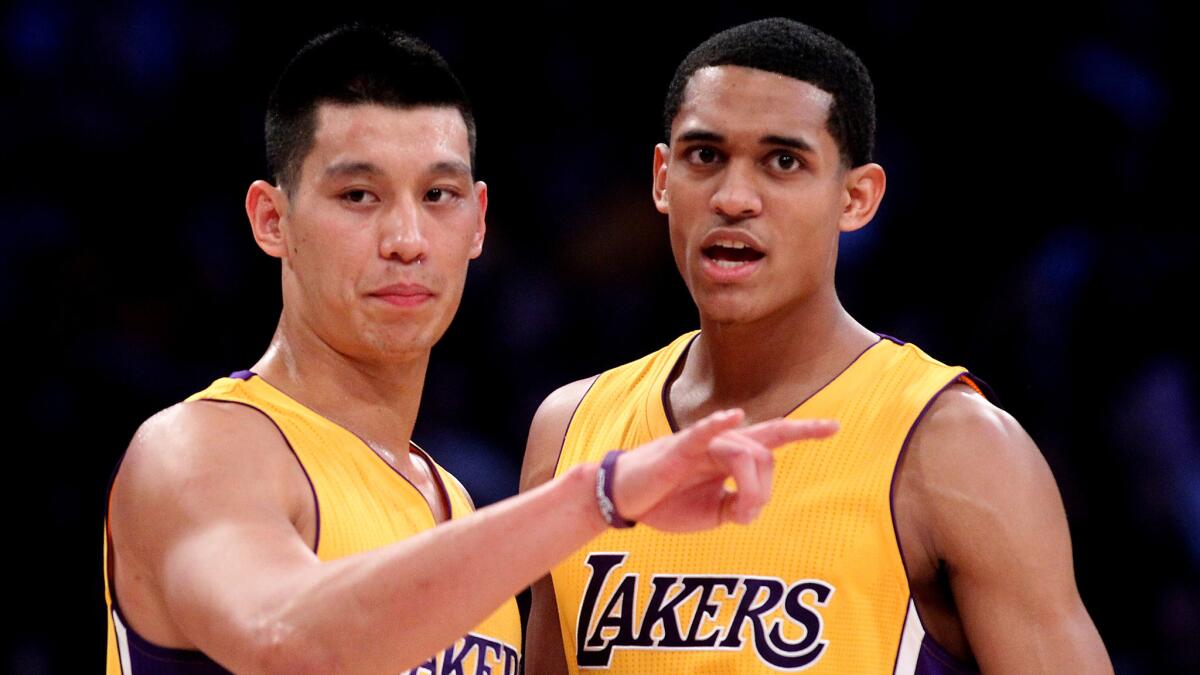 Lakers teammates Jeremy Lin, left, and Jordan Clarkson talk during a win over the Golden State Warriors on Dec. 23.