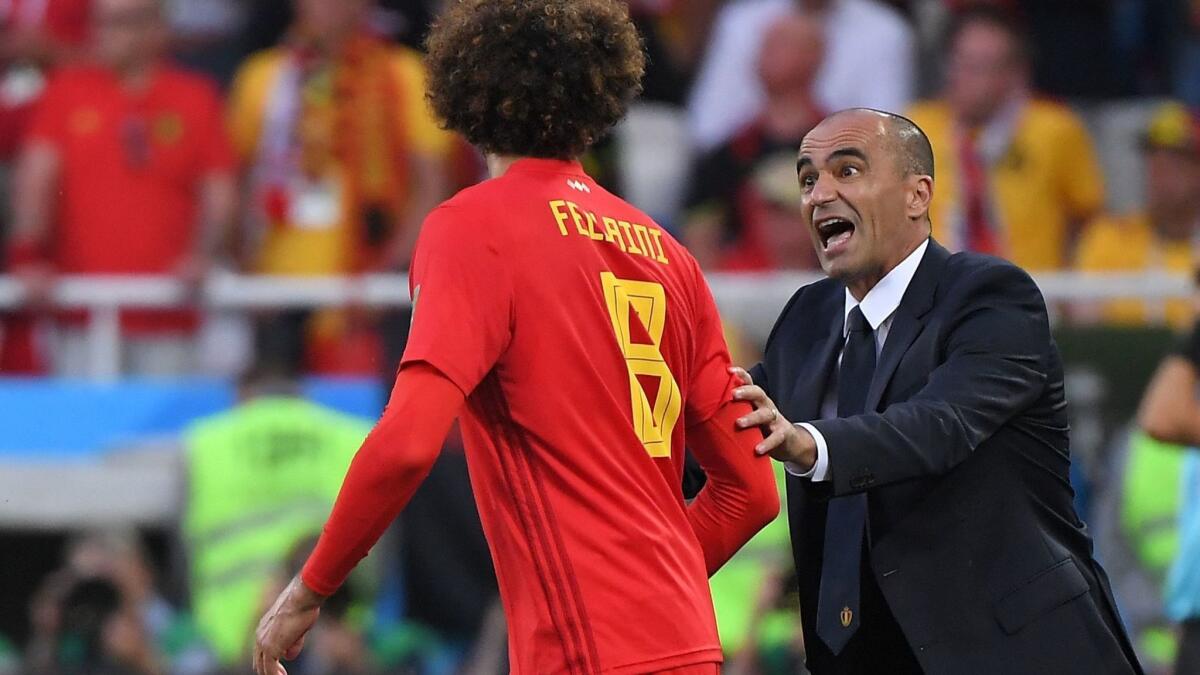 Belgium coach Roberto Martinez talks to midfielder Marouane Fellaini during a 1-0 victory over England in a Group G game Thursday.