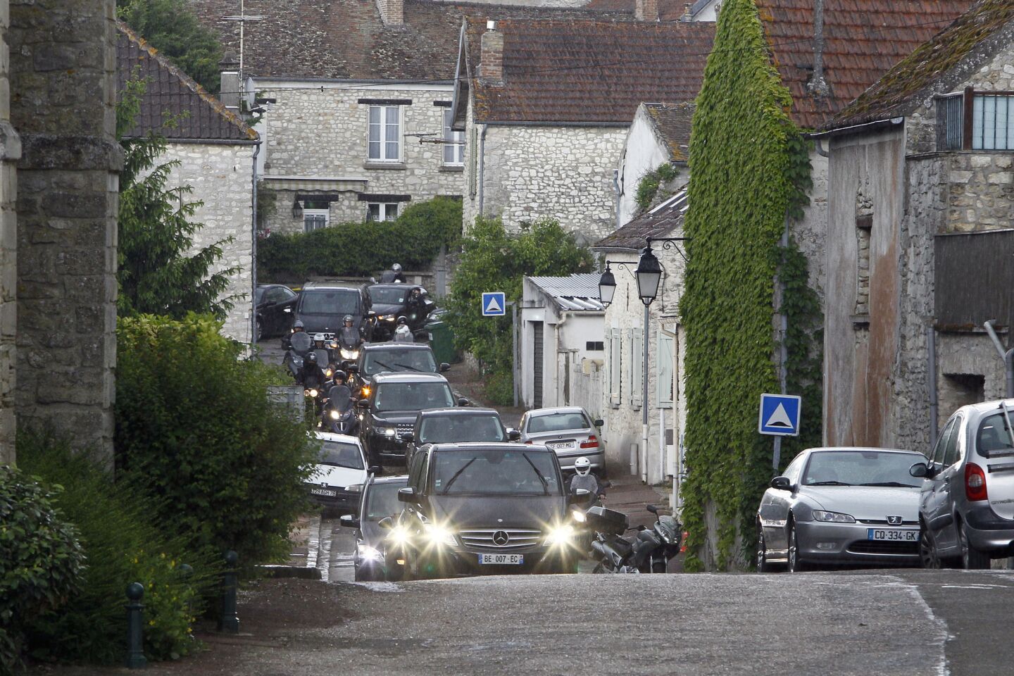 The cars of Kim Kardashian, Kanye West and their guests arrive at the entrance of the Chateau de Wideville in Davron, 35 miles west of Paris, for a pre-wedding brunch on May 23.