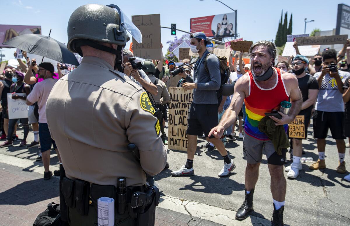 A protester yells at a sheriff's deputy