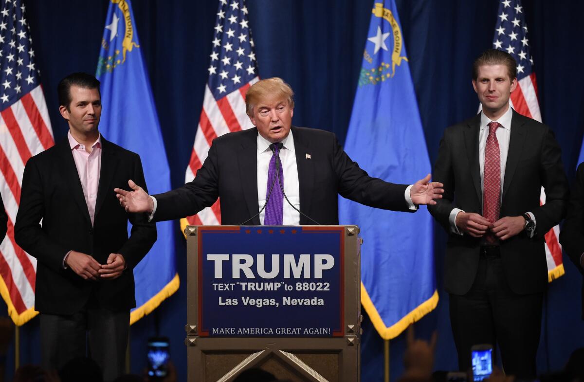 Republican presidential candidate Donald Trump speaks Tuesday night with his sons Donald Trump Jr., left, and Eric Trump at a Las Vegas celebration of his victory in the Nevada caucuses.
