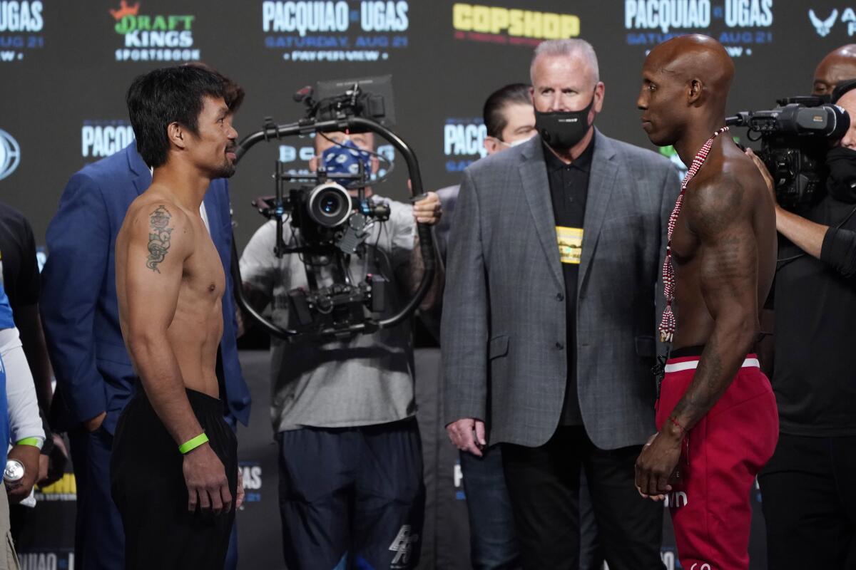 Manny Pacquiao, left, of the Philippines, and Yordenis Ugas