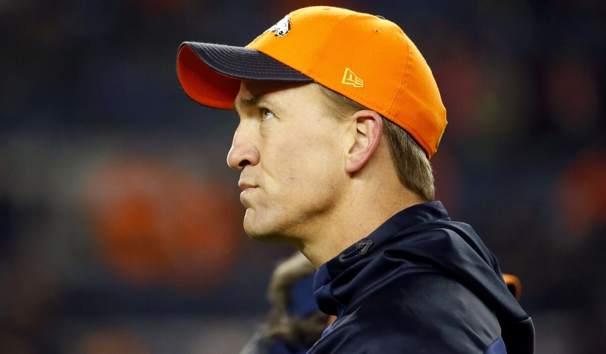 Denver Broncos injured quarterback Peyton Manning watches prior to a game against the New England Patriots on Nov. 29.