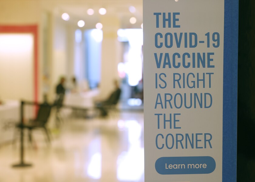A sign is posted at a vaccination booster shot clinic in San Rafael.