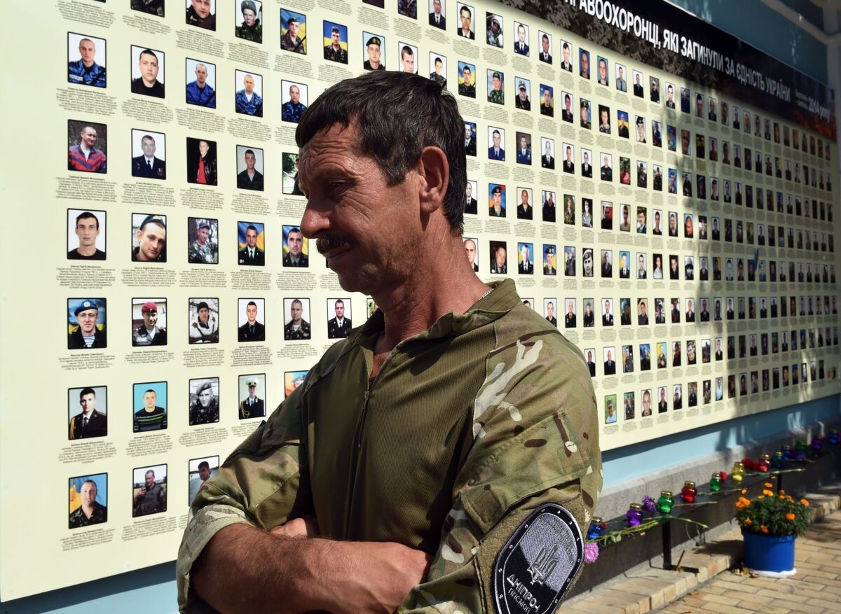 A Ukrainian serviceman reviews a memorial erected in Kiev in late August honoring dead government fighters from the August 2014 battle for Ilovaisk near Donetsk.