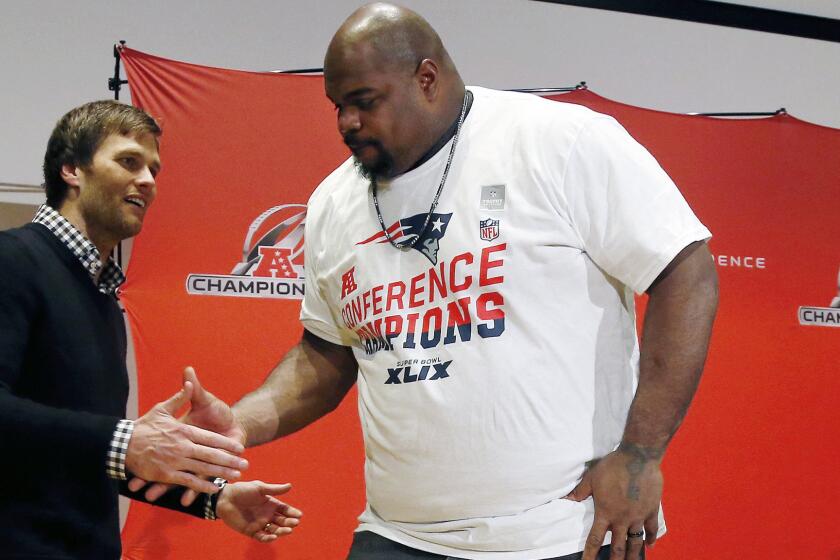 New England Patriots quarterback Tom Brady, left, shakes hands with defensive lineman Vince Wilfork after a win over the Indianapolis Colts in the AFC Championship game Sunday.