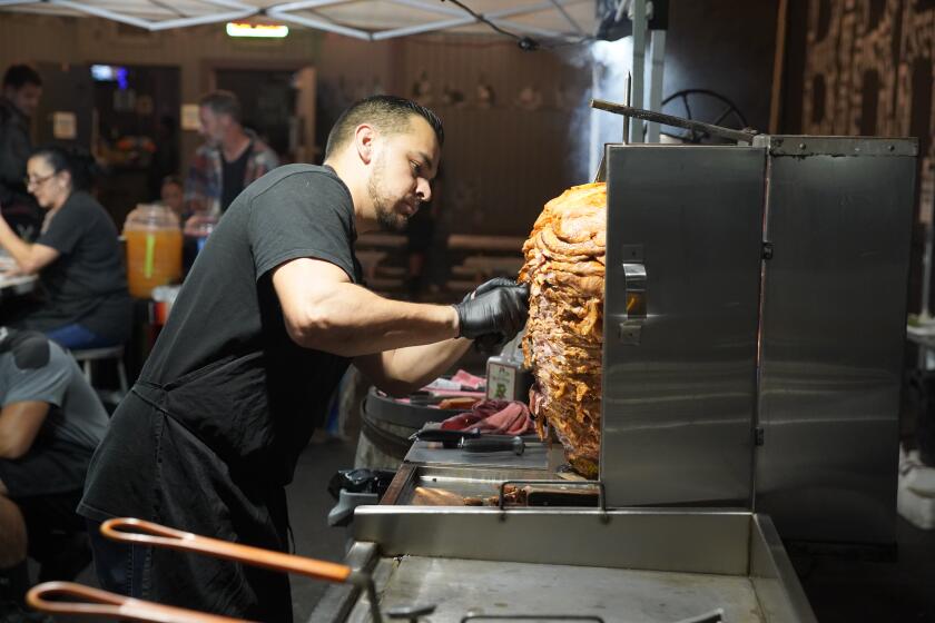 San Diego, CA - November 06: Tacos El Villasana, received a notice from the city to shut down its operations tonight. The business operates from the storefront Machete Beer House. Christian Villasana cuts in the carne adobada in National City on Monday, Nov. 6, 2023 in San Diego, CA. (Alejandro Tamayo / The San Diego Union-Tribune)
