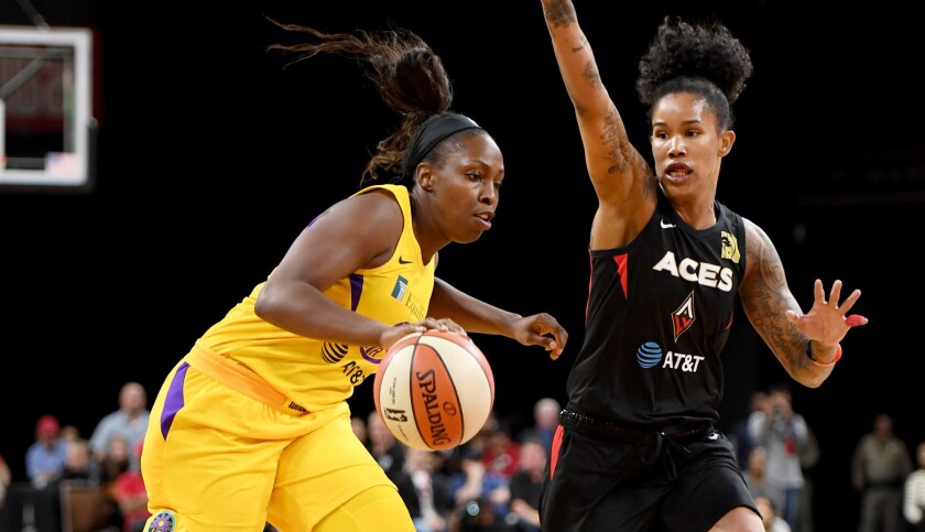 Sparks guard Chelsea Gray drives against Las Vegas Aces forward Tamera Young during the season opener last month.