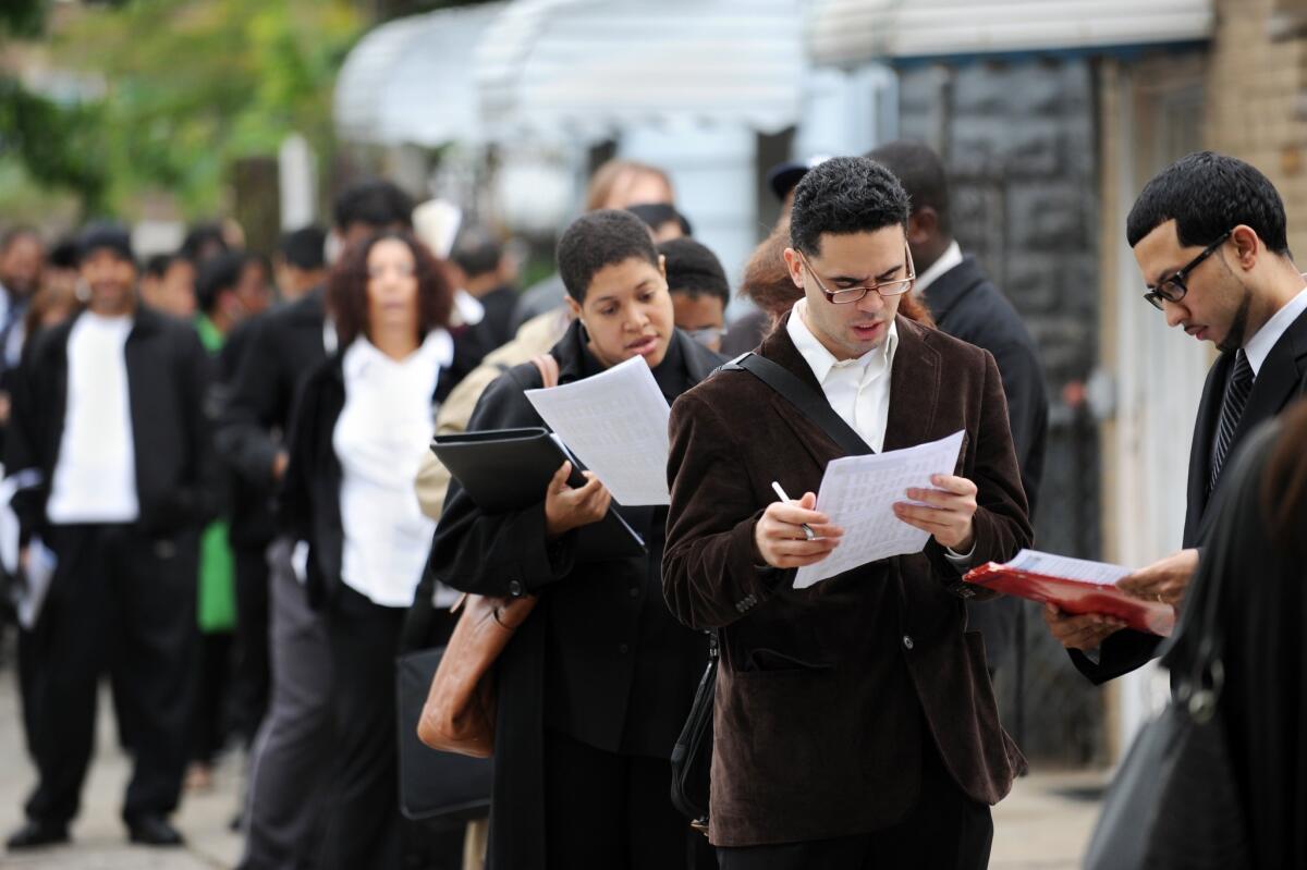 Job seekers wait in line in Queens, N.Y., in May 2012. The job market has greatly improved since then.