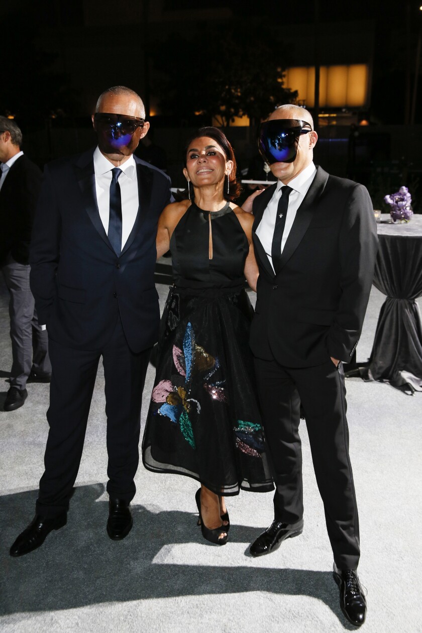  Anoosheh Oskouian is flanked by two masked guests during the 2021 OCMA Art Sense Gala.