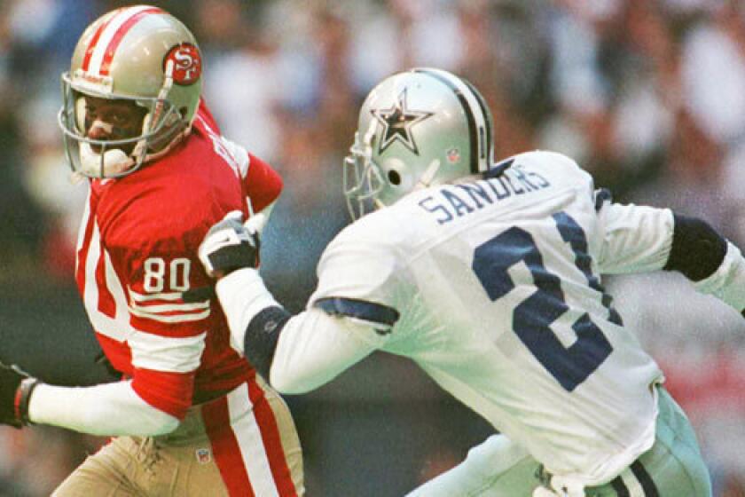 Jerry Rice and Deion Sanders, shown during their playing days in 1996, will be captains for the NFL's Pro Bowl draft in January.