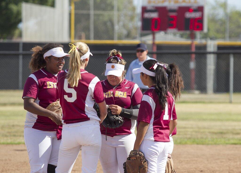 Estancia High softball players conference on the mound in the third inning. Godinez beat the Eagles 18-0 in an Orange Coast League game on Tuesday.