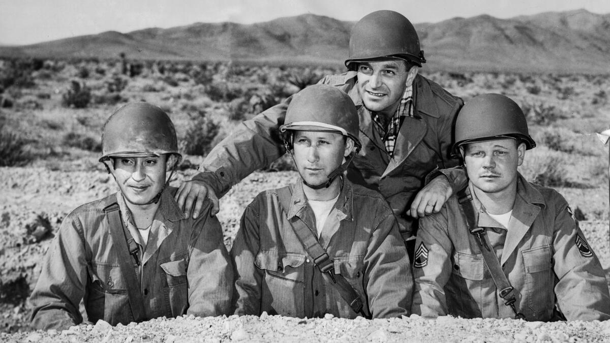 March 15, 1953: Writer Gene Sherman, rear, in advanced position two miles from ground zero. Soldiers with Sherman from the Los Angeles area are from left: D. W. Gonzales, Lt. Willis England and Sgt. Gene Gurr.