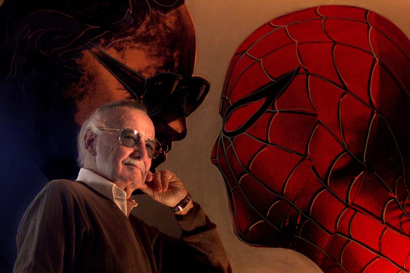 Marvel comic book creator Stan Lee poses with a painting of himself and Spider-Man at his home in Los Angeles in 2002.