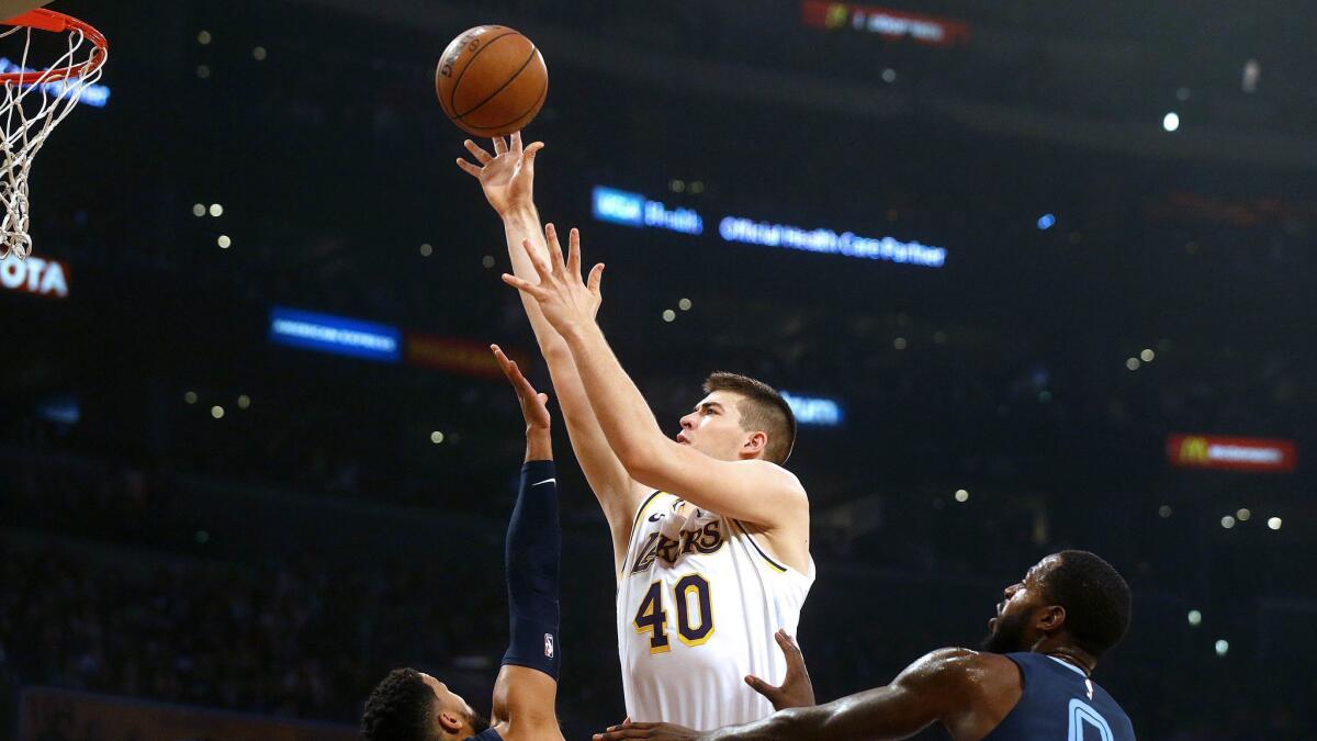 Lakers center Ivica Zubac (40) shoots over Memphis Grizzlies guard Garrett Temple (17) and Memphis Grizzlies forward JaMychal Green (0) in the first half at the Staples Center on Dec. 23, 2018.