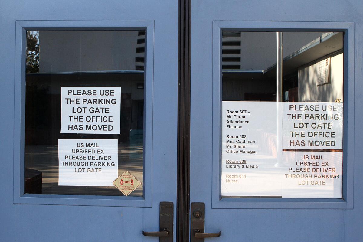 The entry to the main office has signs redirecting parents and visitors to an alternative location on Friday, Oct. 11, 2013. The roof, installed on Jordan Middle School in August 2013, is emitting a strong odor that has the office staff working elsewhere on the Burbank campus.