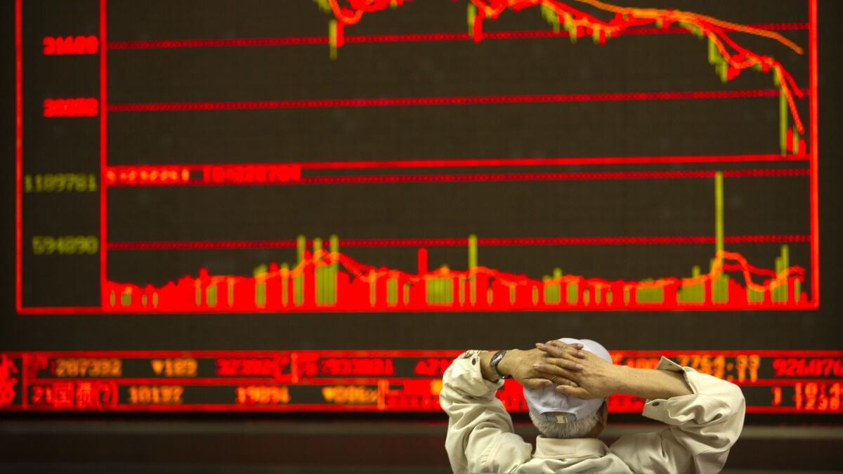 An investor monitors stock prices at a brokerage house in Beijing on Friday.