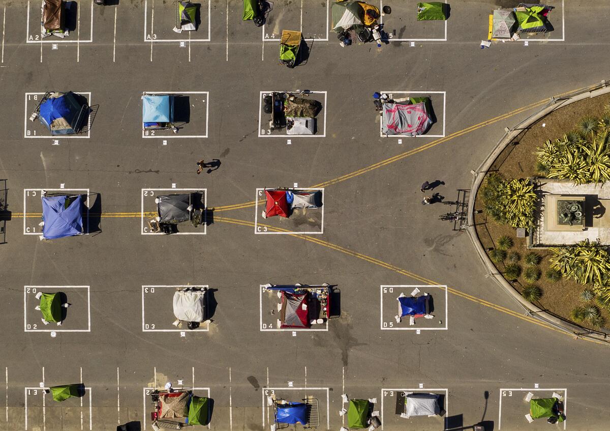 Separated rectangles designed to help prevent the spread of the coronavirus line a city-sanctioned homeless encampment at San Francisco's Civic Center.