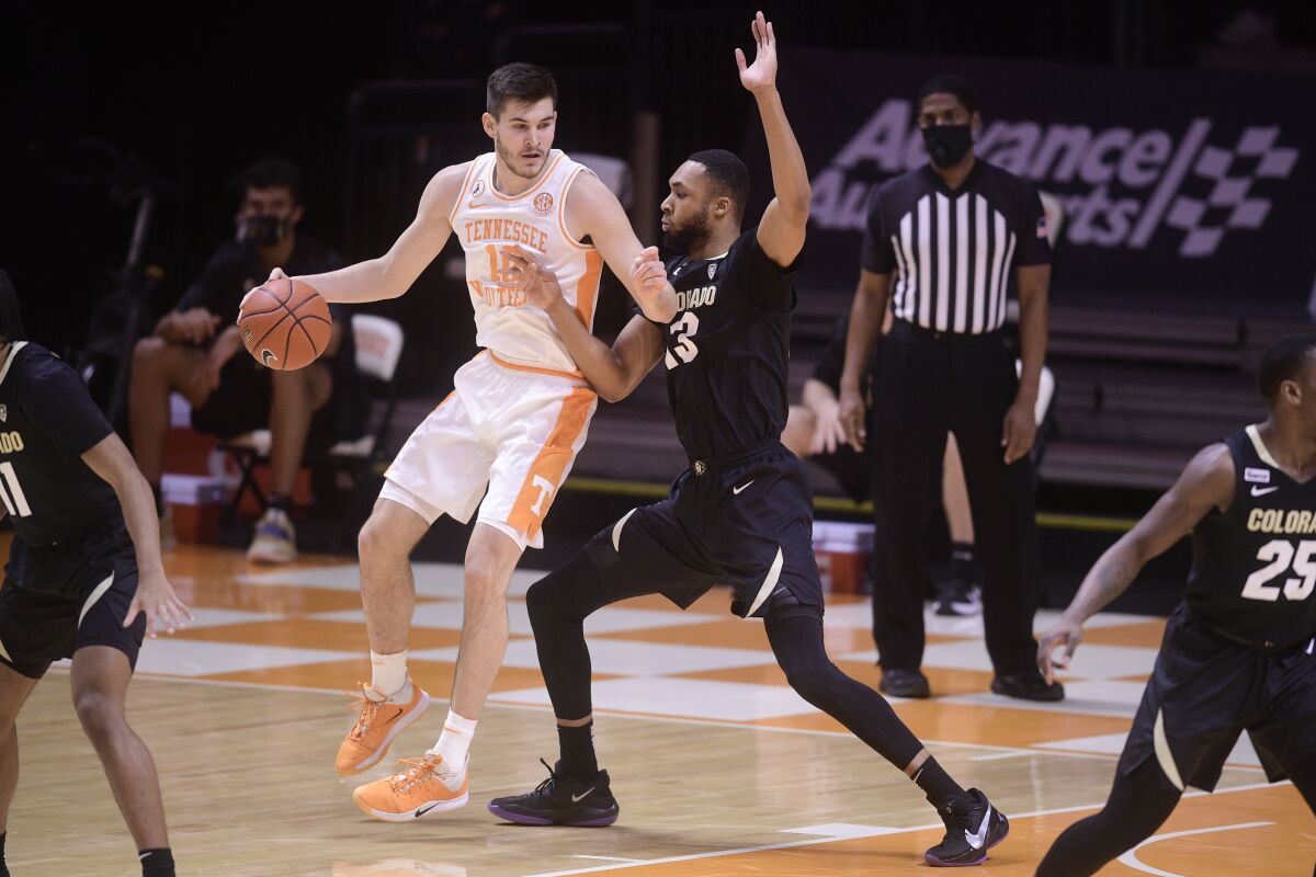 Tennessee's John Fulkerson (10) looks to get around Colorado's Dallas Walton (13) during an NCAA college basketball game Tuesday, Dec. 8, 2020, in Knoxville, Tenn. (Caitie McMekin/Knoxville New-Sentinel via AP, Pool)