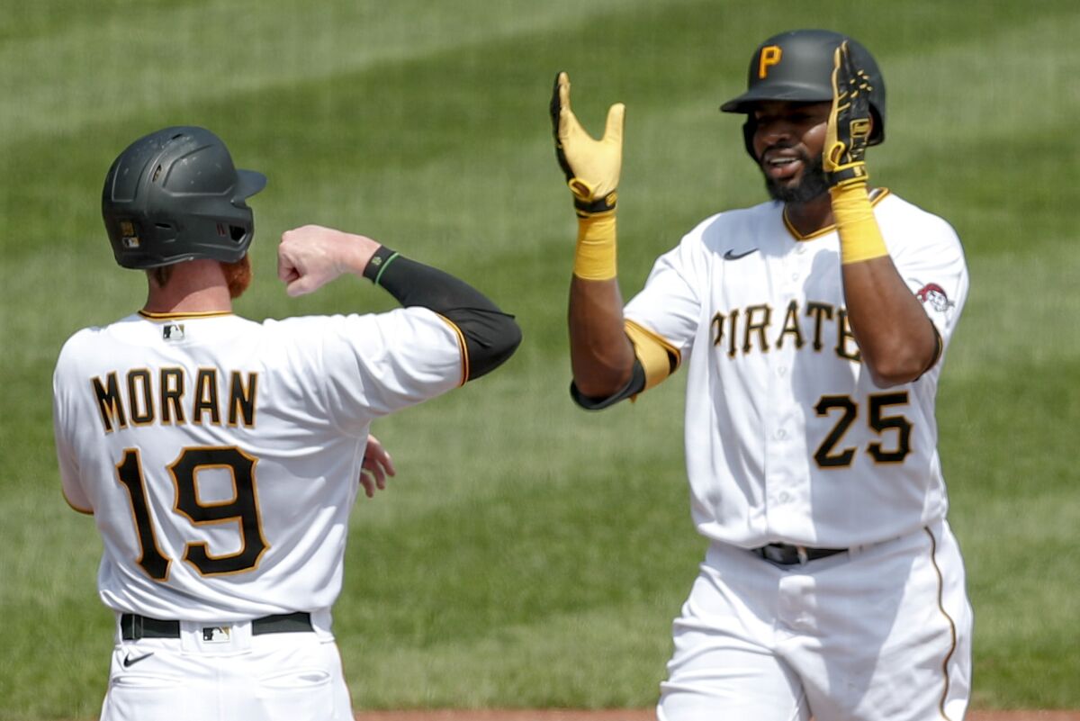 Pittsburgh Pirates' Gregory Polanco (25) celebrates with Colin Moran (19) after driving him and Bryan Reynolds in with a three run home run in the second inning of a baseball game against the Minnesota Twins, Thursday, Aug. 6, 2020, in Pittsburgh. (AP Photo/Keith Srakocic)