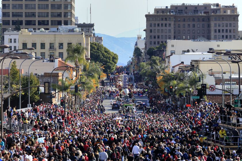 PASADENA CA., JANUARY 1, 2020: The Crowds of spectators follow the final floats and bands down Colorado Blvd at the end of the 131st Rose Parade (Mark Boster For the LA Times).
