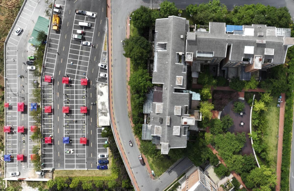 An aerial view of buildings and a parking lot.