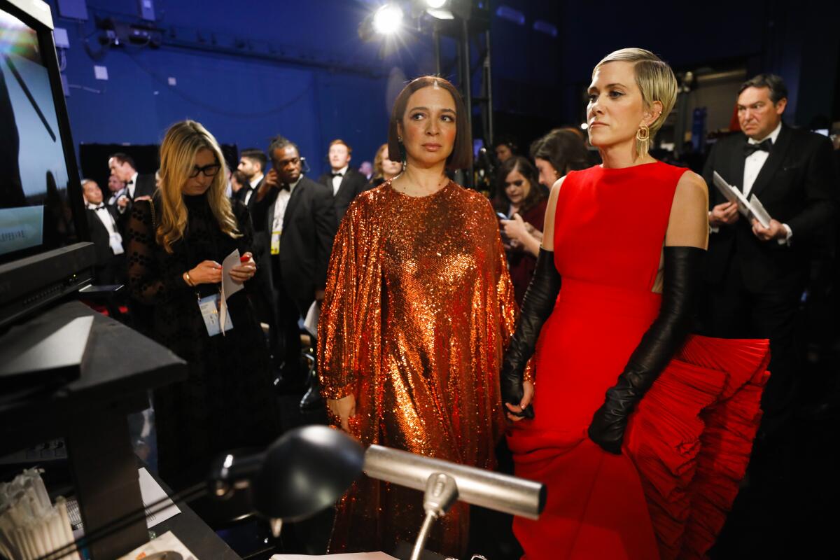 Maya Rudolph, left, and Kristen Wiig backstage at the Dolby Theatre.