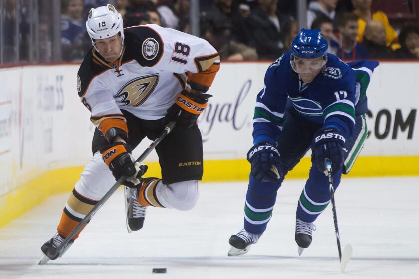 Ducks forward Tim Jackman drives up the right side of the ice against Canucks forward Radim Vrbata. Jackman just signed a one-year extension with the Ducks.