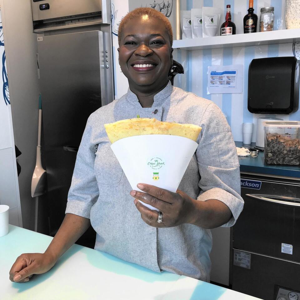 Chef and owner Mawa McQueen serves a savory crepe at the new Crepe Shack by Mawa’s Kitchen in Snowmass Village, Colo.