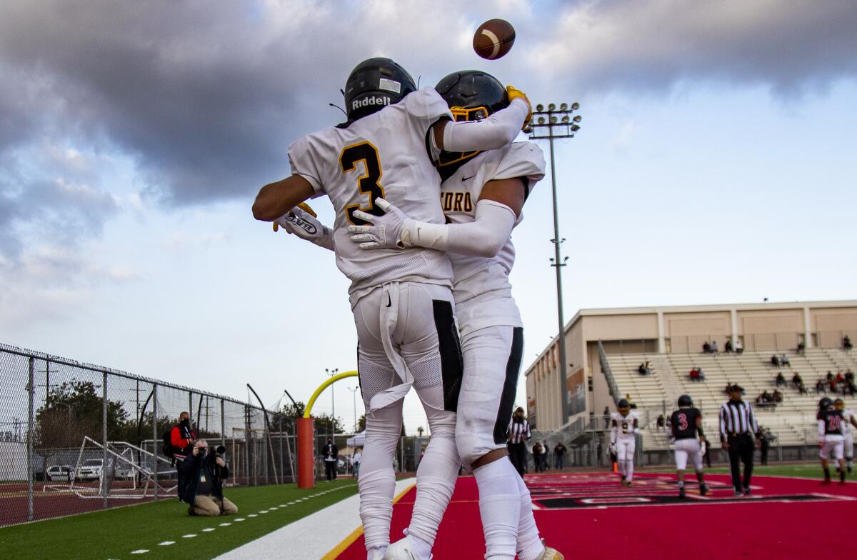 San Pedro's Robert Sarmiento (3) celebrates with Roman Sanchez (8) after scoring a touchdown against Wilmington Banning.