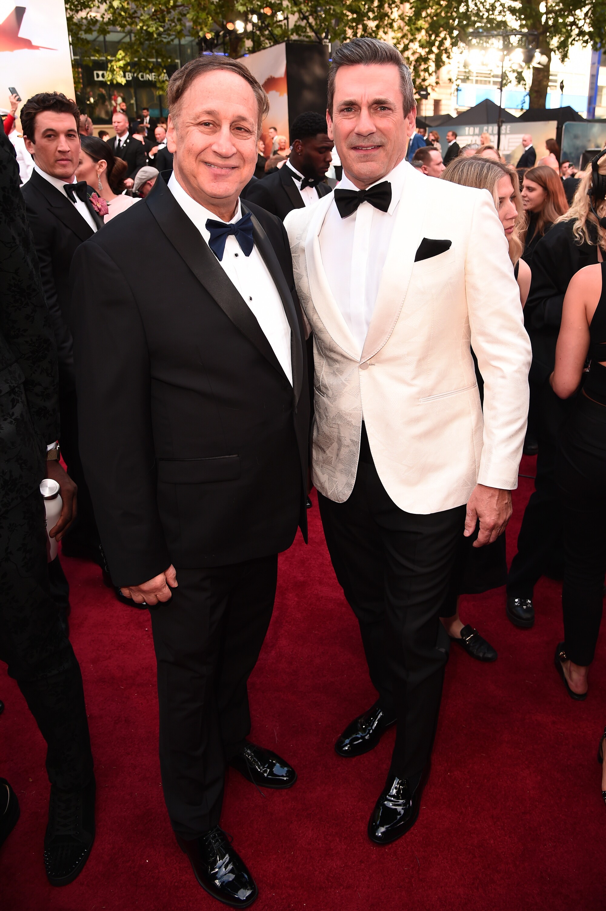 Two men in tuxedoes on the red carpet