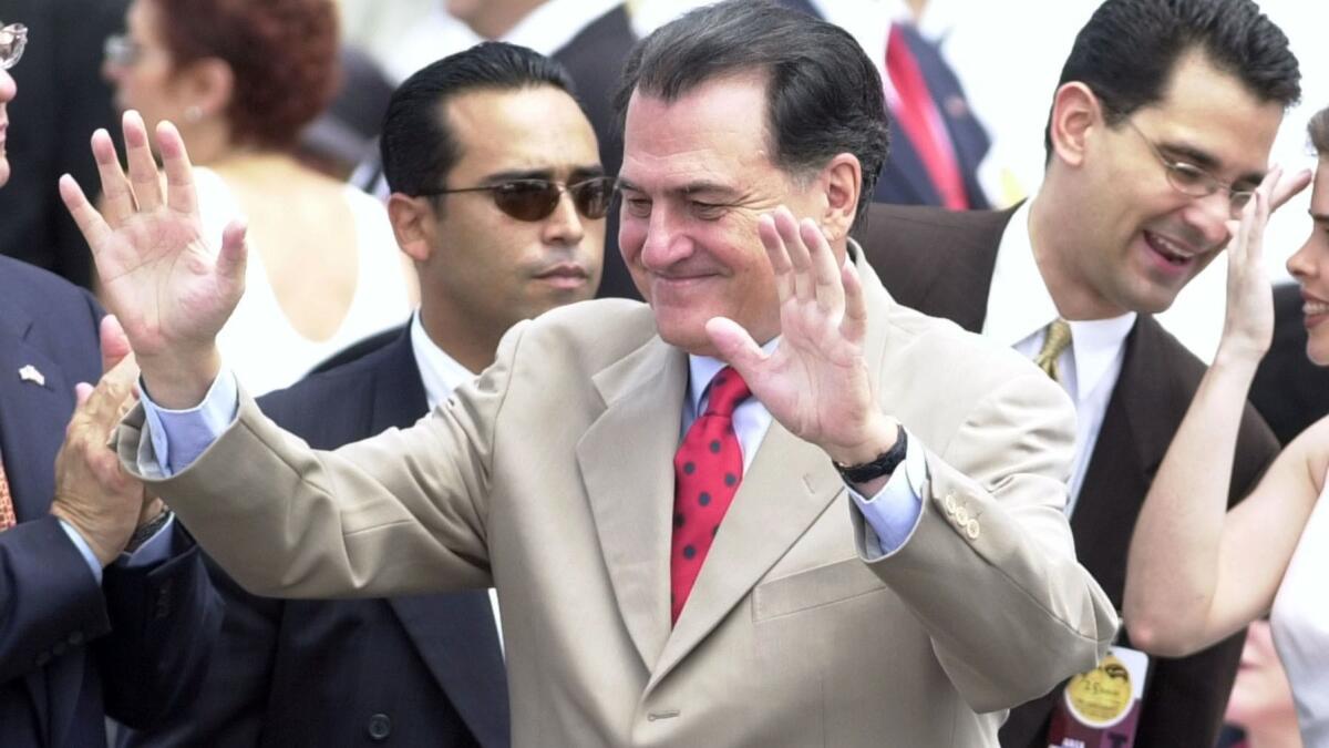 Former Puerto Rican Gov. Rafael Hernández Colón waves to the crowd during a celebration at the Capitol in San Juan, Puerto Rico, in 2002.