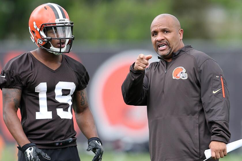 Cleveland Browns head coach Hue Jackson, right, gives directions to Browns wide receiver Corey Coleman during mini camp on June 7.