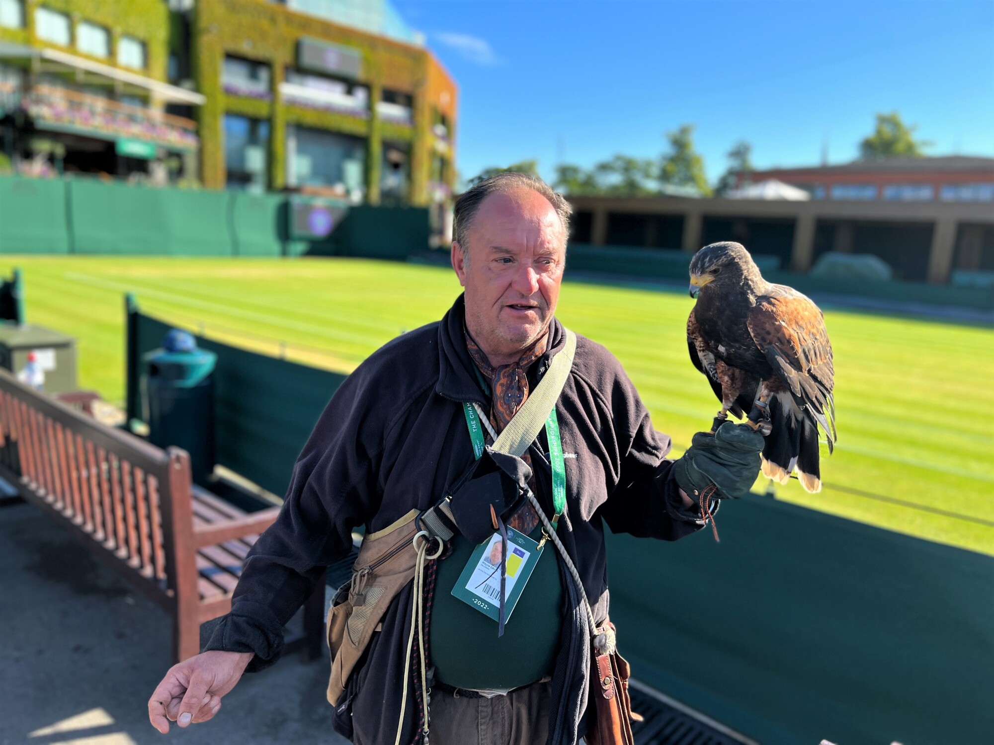 Wayne Davis se promène avec Rufus autour d'un court extérieur au All England Lawn Tennis & Croquet Club.