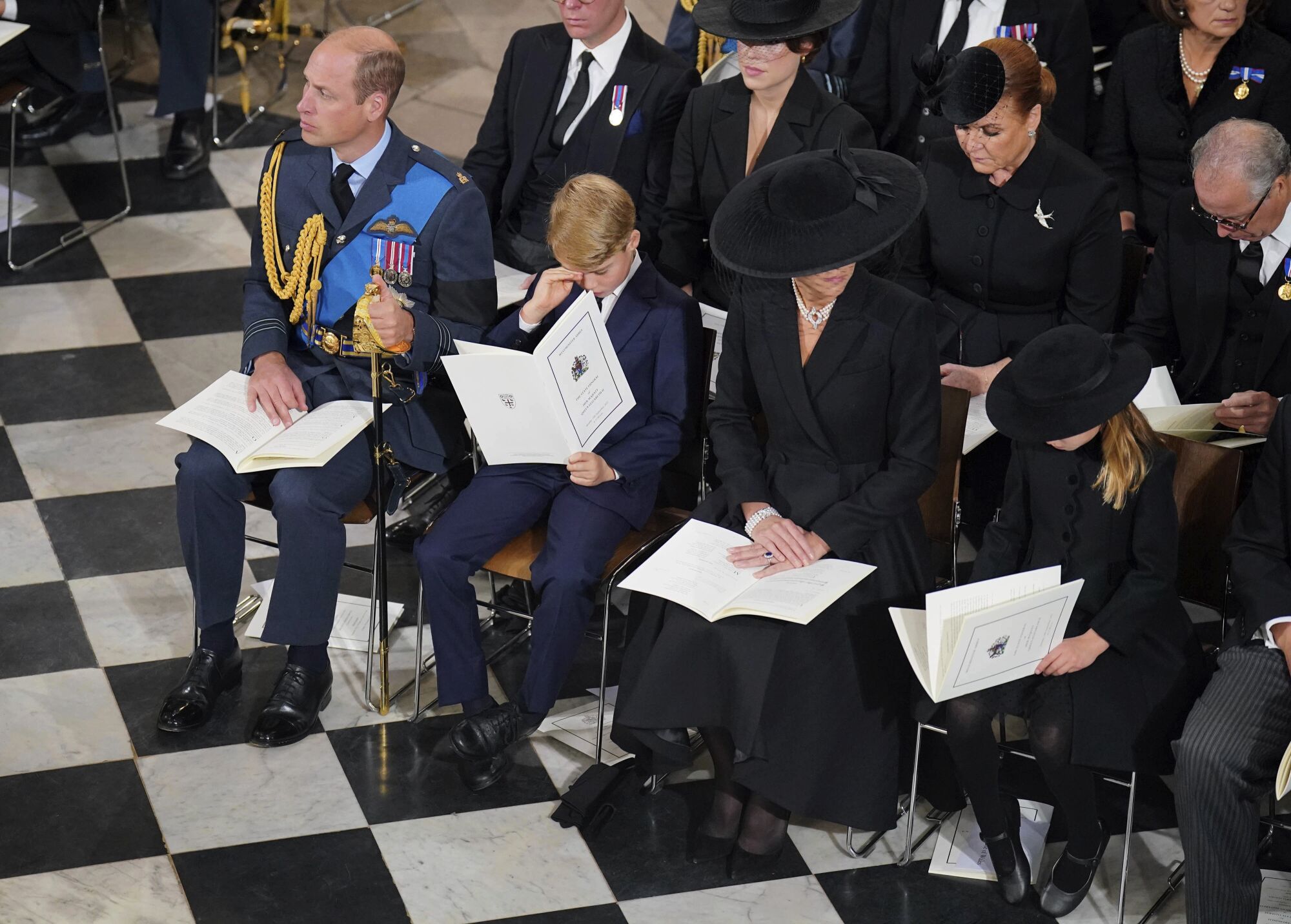 William, Prince of Wales; Prince George; Catherine, the Princess of Wales; and Princess Charlotte attend the queen's funeral.