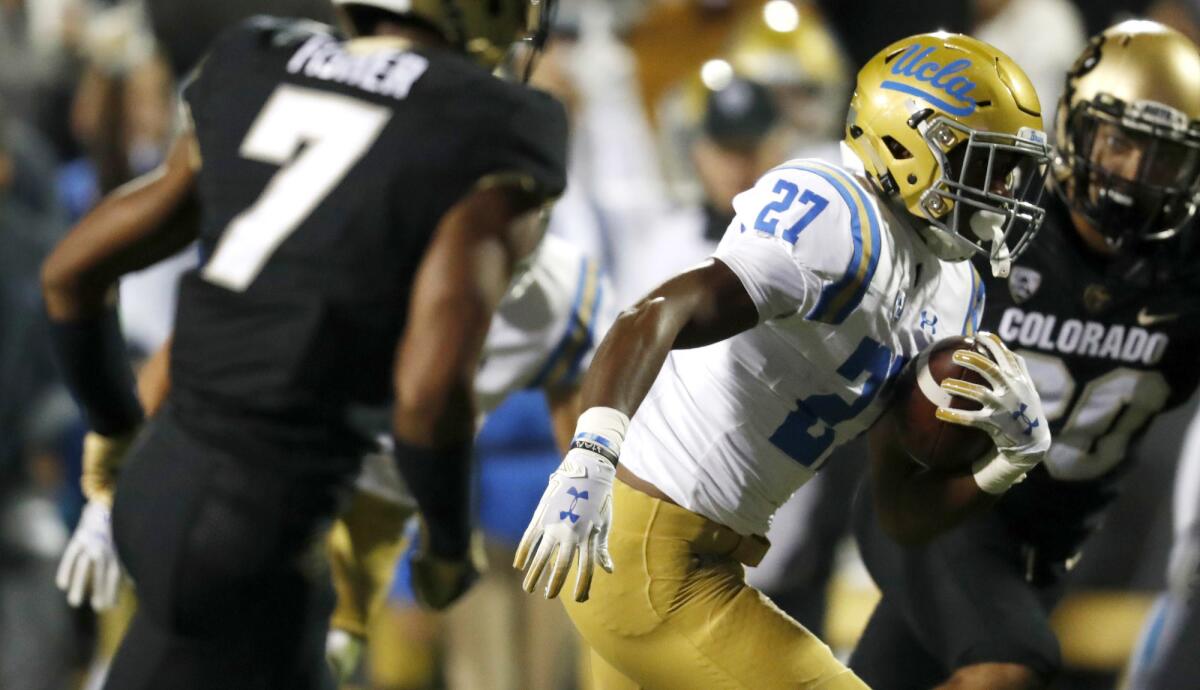 UCLA running back Joshua Kelley finds a hole through the line against Colorado on Friday night.