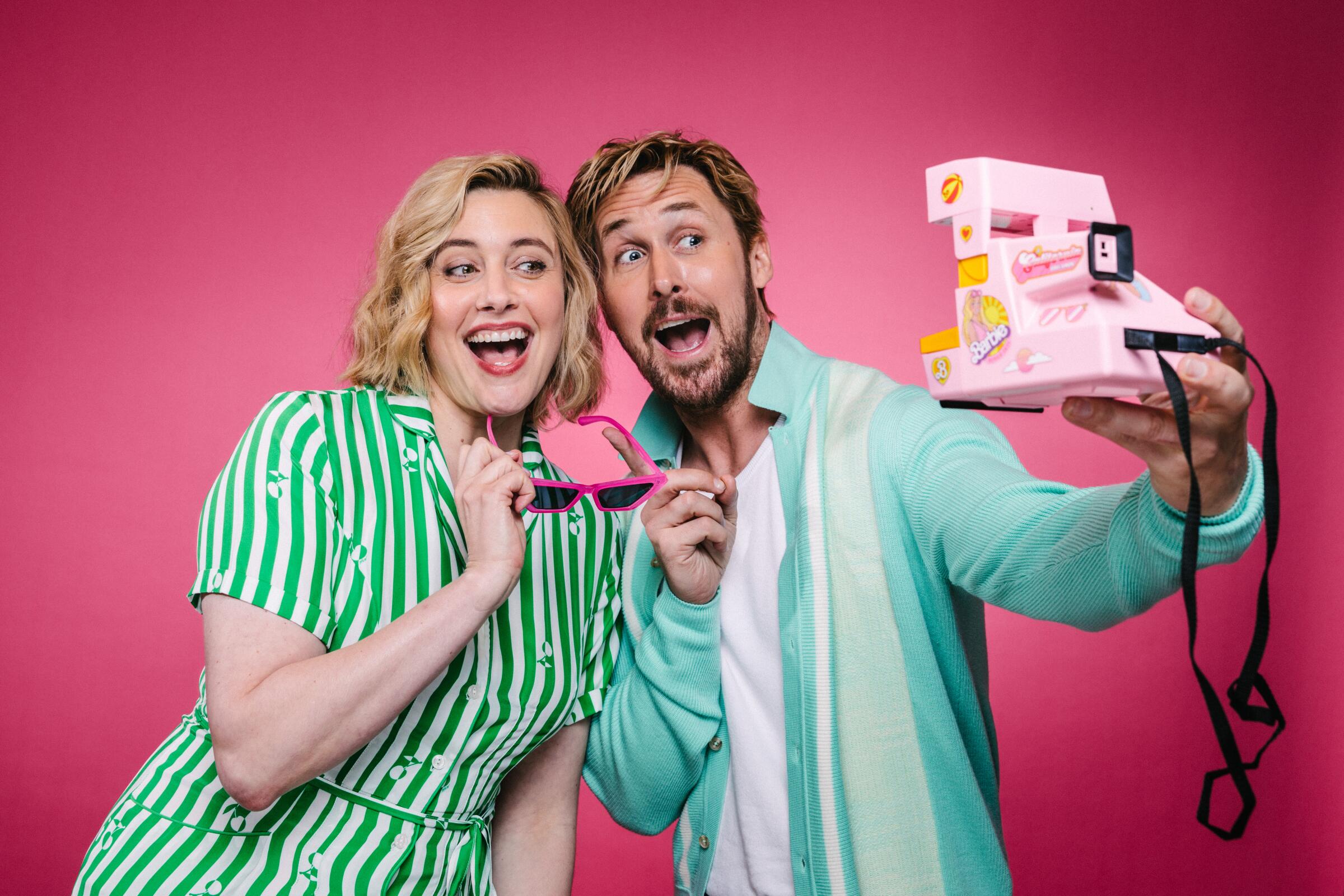 "Barbie" filmmaker Greta Gerwig and her Ken, Ryan Gosling, playfully pose for a pink Polaroid camera.