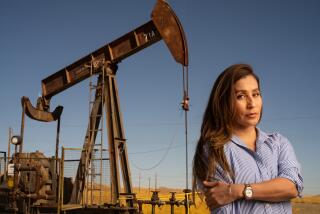 COALINGA CA SEPTEMBER 29, 2023 - Argelia Leon stands near an oil pumpjack in Coalinga. Images are for a commentary piece out of Coalinga about the oil industry's Levanta Tu Voz program, which is aimed at Latinos and raising questions about the transition from fossil fuels to renewable energy and electrification. (Tomas Ovalle / For The Times)