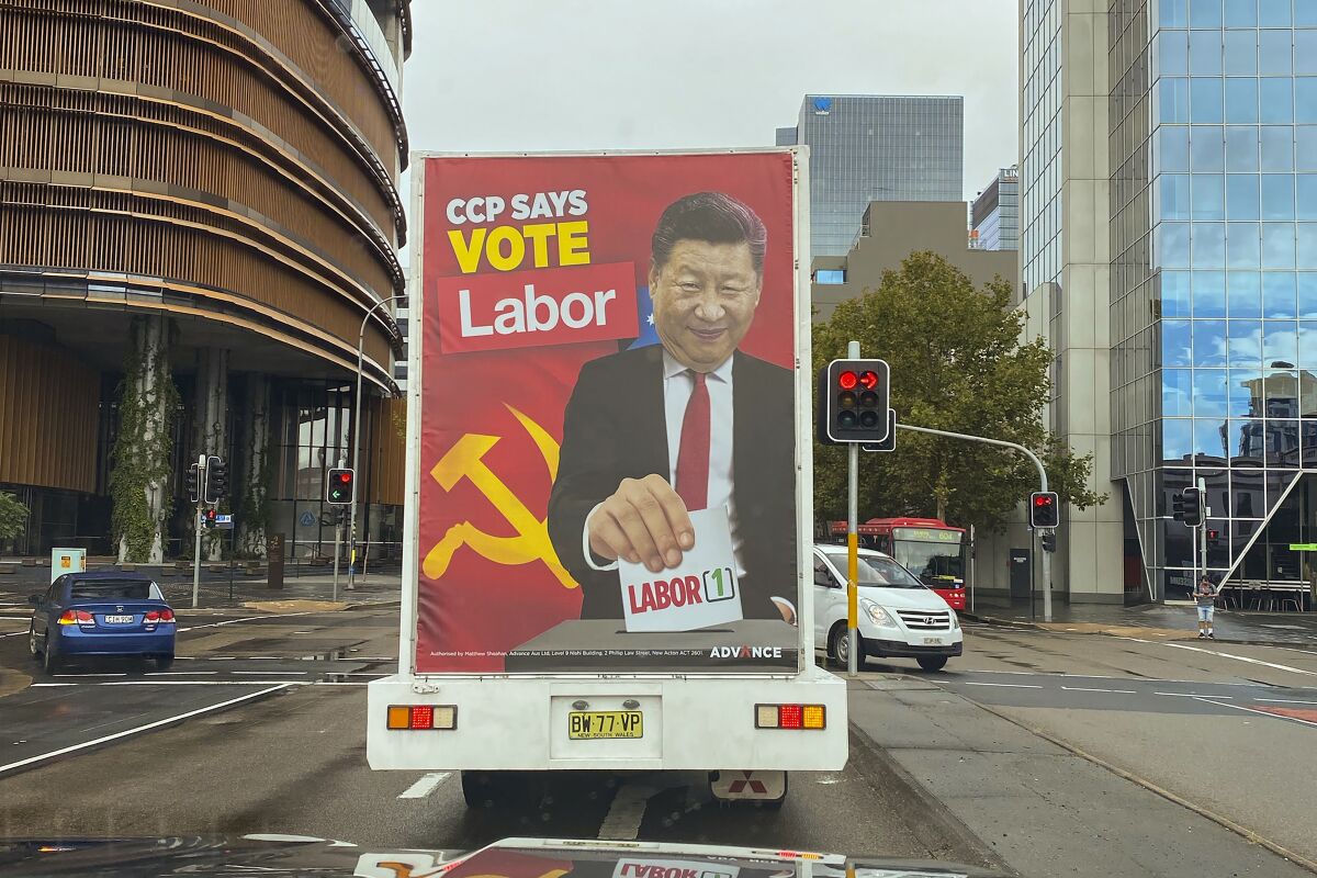 FILE - A truck sponsored by conservative lobby group Advance Australia displaying an image of Chinese President Xi Jinping casting a vote for the Australian opposition Labor Party drives down a local street, Saturday, April 9, 2022, in the Parramatta area of Sydney. The previous Australian government’s stance against a more aggressive China drove away many Chinese-Australian voters at recent elections who considered the administration’s language had licensed racism, a campaign strategist said on Wednesday, June 15, 2022. (AP Photo, File)