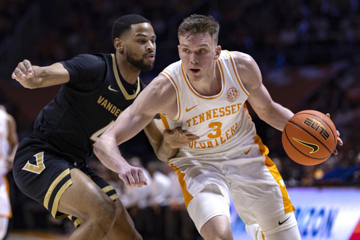 Tennessee guard Dalton Knecht (3) drives as Vanderbilt guard Isaiah West (4) defend during the first half of an NCAA college basketball game Saturday, Feb. 17, 2024, in Knoxville, Tenn. (AP Photo/Wade Payne)