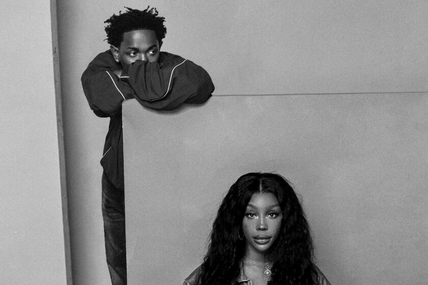 Black and white photo of Kendrick Lamar leaning against a wall and SZA kneeling on a floor