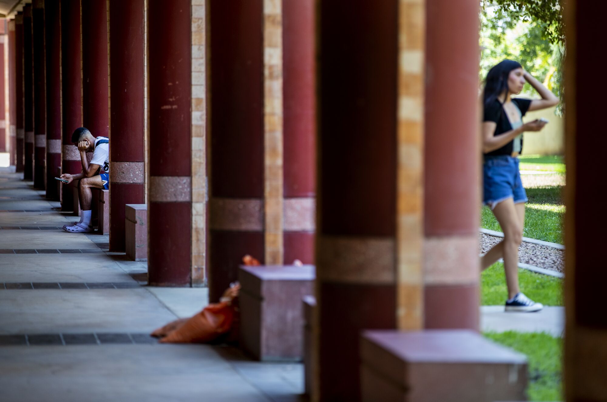 A UC Riverside student checks his phone at the Humanities building