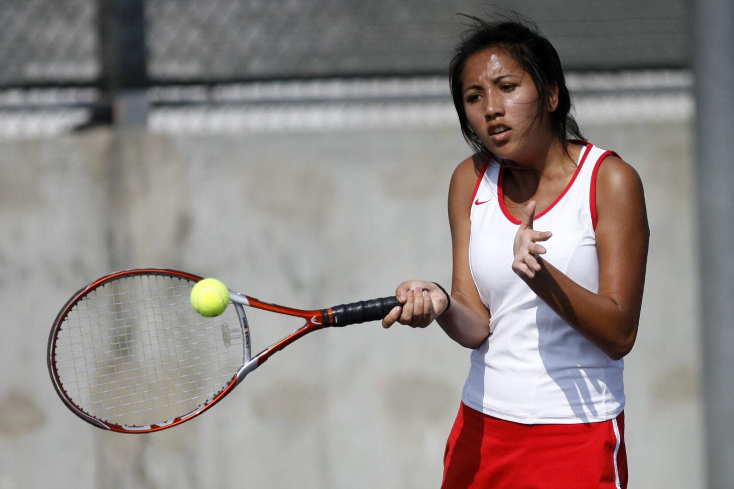 Burroughs' Alicia Singhanate hits the ball during a match against Hoover at Hoover High School in Glendale on Tuesday, September 11, 2012.