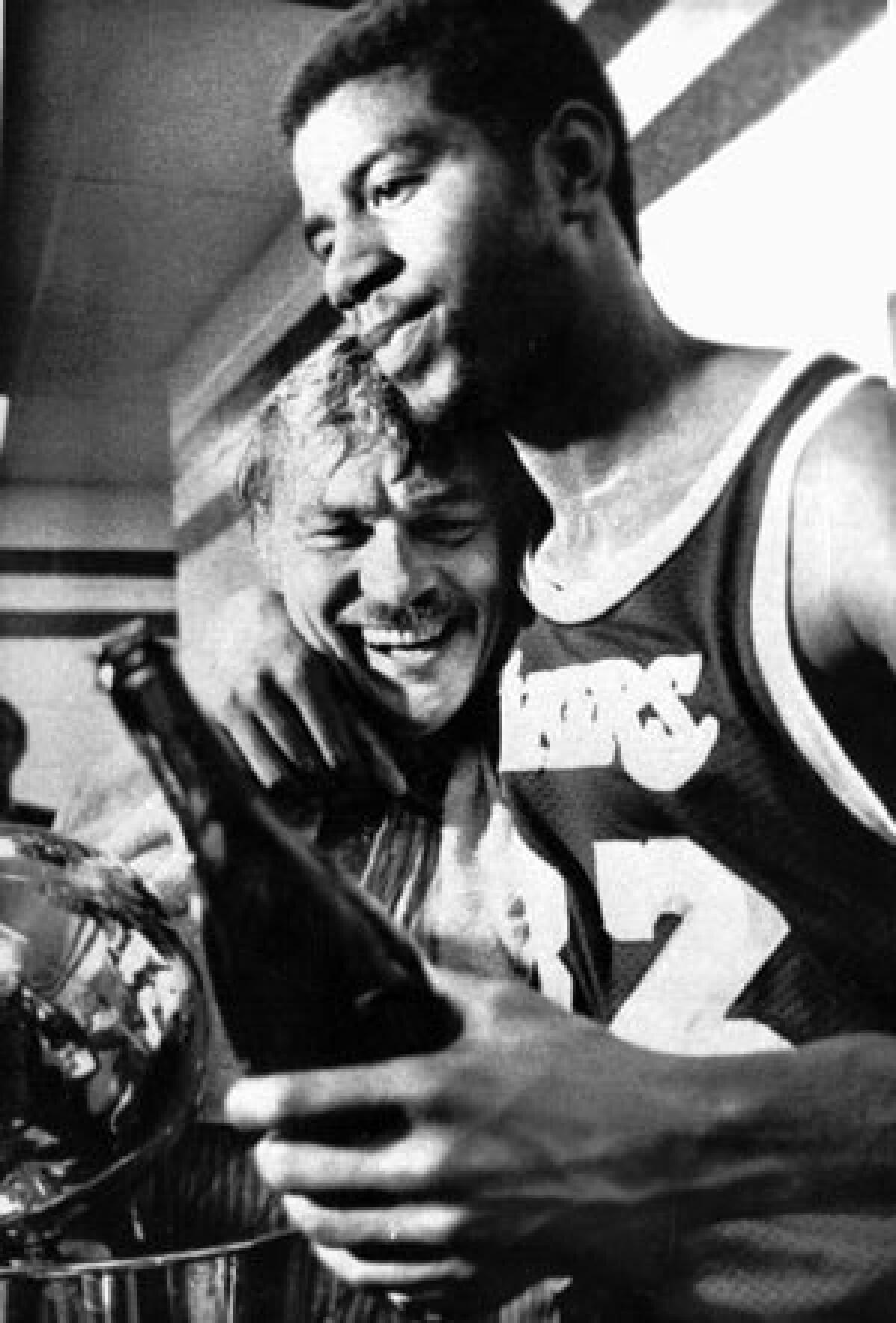 Magic Johnson and Jerry Buss celebrate the Lakers' title in 1980. It was their first NBA title as team owner and player.