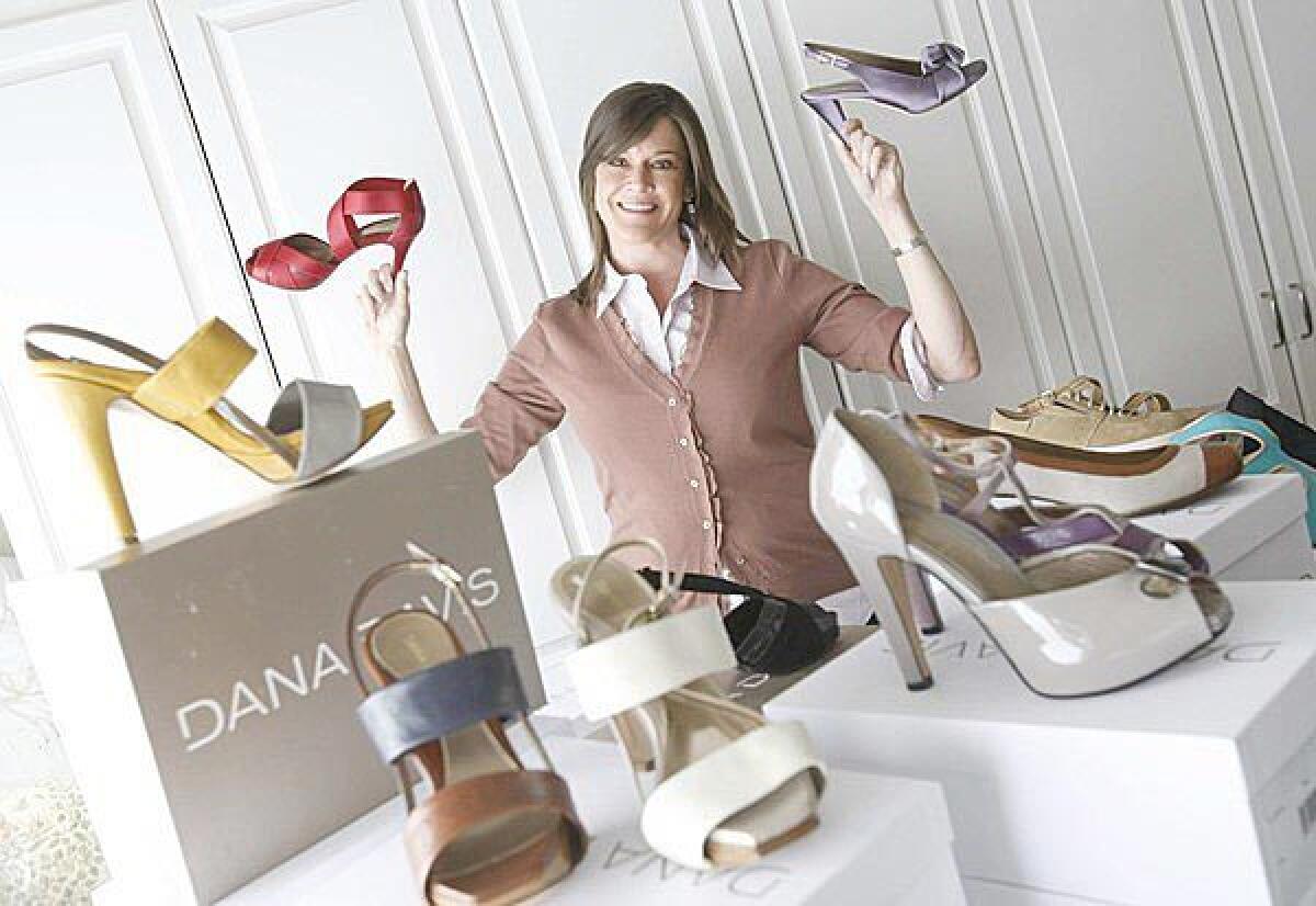 Dana Davis, shown here in her Brentwood home, with some of her high-fashion orthotic shoes. Sarah McLachlan, Anne Hathaway and Vivica Fox are among the celebrities who have worn Davis' creations.