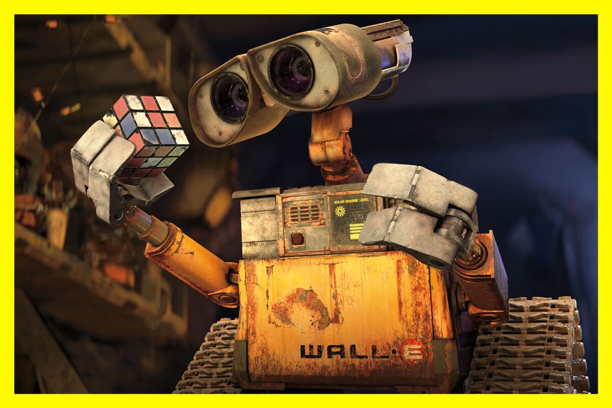 A robot holds and looks at a Rubik's Cube in the film "WALL-E." 