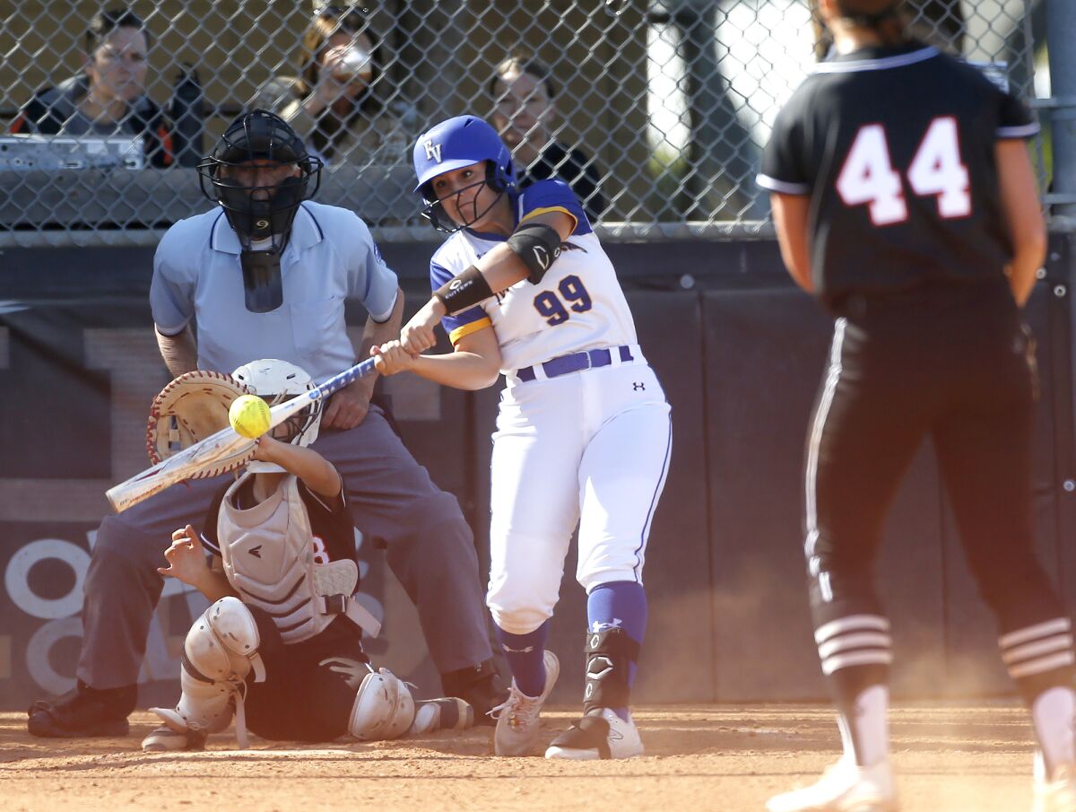 Fountain Valley's Veronica Moore (99) hits a double in a Sunset League softball game against Huntington Beach on Tuesday.