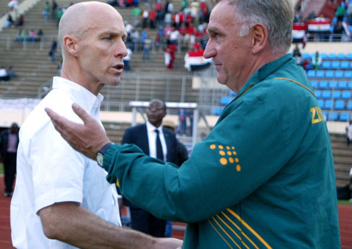 Egypt Coach Bob Bradley, left, greets Zimbabwe Coach Klaus Dieter Pagels after their World Cup qualifying game Sunday.