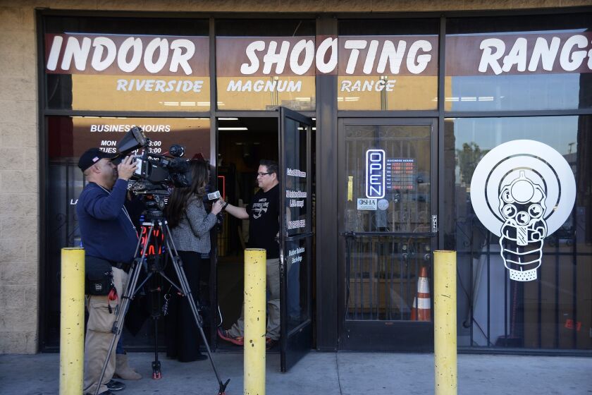 A news crew interviews an employee of the Riverside shooting range where FBI sources say Syed Farook practiced before going on a shooting rampage.