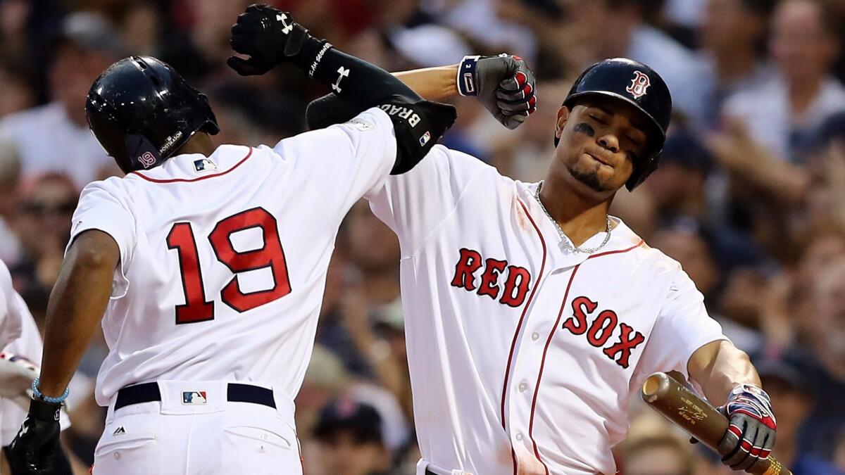 Boston Red Sox center fielder Jackie Bradley Jr. (19) celebrates with shortstop Xander Bogaerts after hitting a three-run home run in the seventh inning of Game 3 against the Houston Astros.